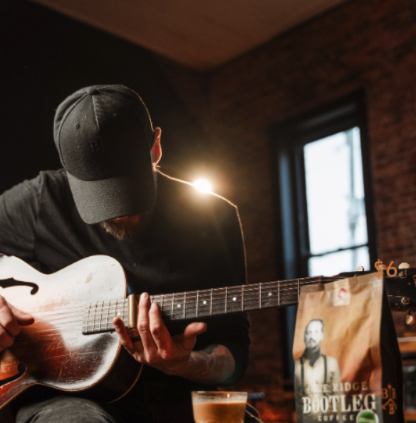 Matt King playing guitar with Blue Ridge Bootleg Coffee
